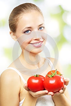 Girl with three red tomatoes