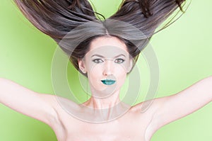 Girl throwing hair up as beauty posing concept