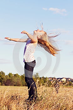 Girl throwing head back in wind