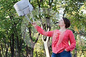 Girl Throwing Her Bag in the Air in a Park