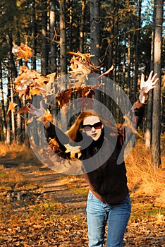 Girl throwing leaves