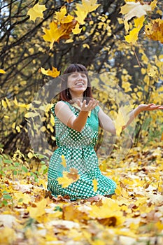 Girl throwing leaves in the air