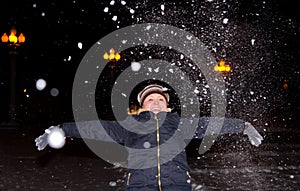 Girl throws up an armful of snow