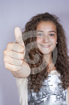 Girl with thumbs up, happy and successful photo