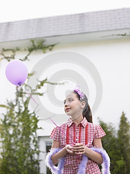 Girl In Tiara And Feather Boa Holding Balloon