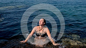 a girl tied with ropes floats in the water