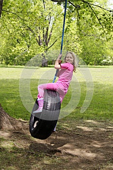 Girl on tire swing