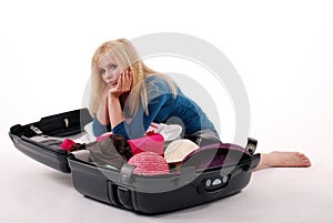 Girl to packing one's things into a suitcase