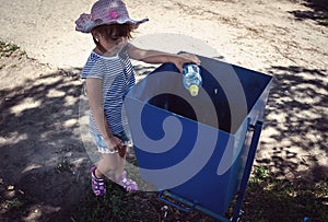 Girl to throw away trash in the trash