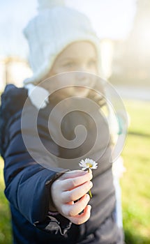 Girl toddler holding a daisy flower