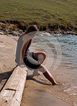 Girl with toes in the sea