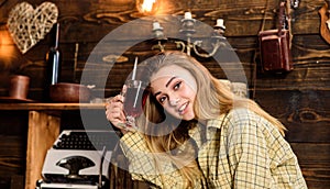 Girl tomboy relax with glass with mulled wine in house of gamekeeper. Relax concept. Lady on happy face in plaid clothes photo
