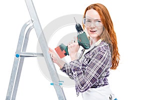 girl with a tool stands on a stepladder