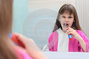 The girl from toothache decided to brush her teeth photo