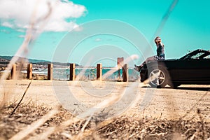 Girl on top of Convertible at Half Moon Bay, California