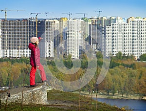 Girl from the top looks at the city of Kiev.