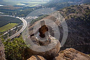 A girl at the top of Mount Precipice with a view of Nazareth in Holy Land