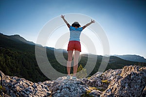 Girl at the top of the mountain.