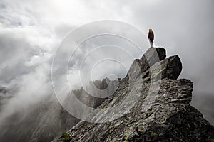 Girl on top of a Rocky Mountain