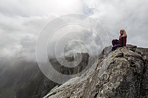 Girl on top of a Rocky Mountain