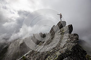 Girl on top of a Rocky Mountain