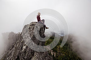 Girl on top of a Rocky Mountain