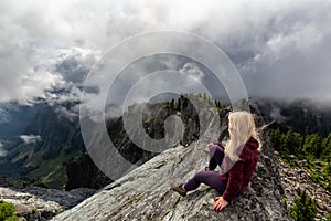 Girl on top of a Rocky Mountain