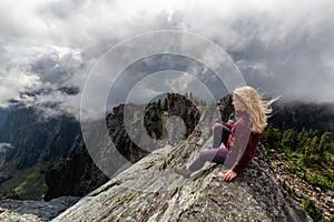 Girl on top of a Rocky Mountain