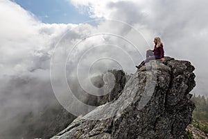 Girl on top of a Rocky Mountain
