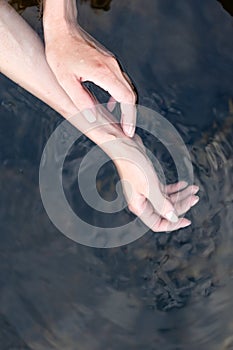 Girl touch water, closeup view