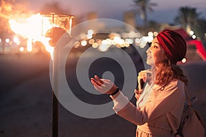 Girl touches the fire torch. Pagan beliefs, spirituality, and the fire-worship concept