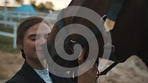 Girl Touching Her Face To The Seal Brown Horse Holding Its bridle Expressing Love