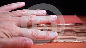 Girl Touching Pages of an Old, Ancient, Antique, Thick Red Book with Fingers