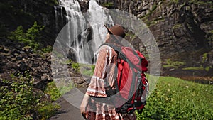 Girl tourist on the background Wonderful landscapes of Norway. Hordaland. Beautiful scenery of the Skjervsfossen