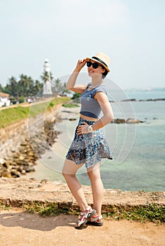 Girl tourist Galle hat sunglasses sunny joy lighthouse