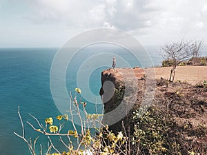 Girl tourist standing on the cliff