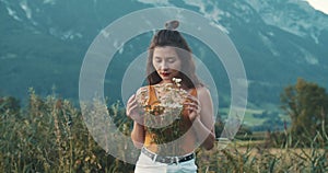 Girl tourist standing on cliff at seaside. The mood of cinematography, gentle tones, alpine meadows and Austrian