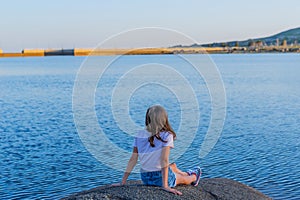 Girl tourist standing overlooking the lake