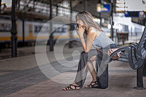 Girl tourist waiting patiently on the train platform