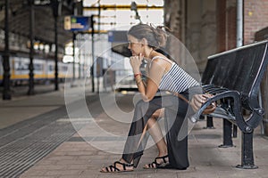 Girl tourist waiting patiently on the train platform