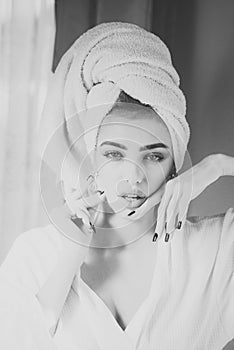 Girl with towel on head relaxing, after spa or shower