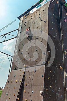 The girl on the tower of climbers conquers the peaks in an extreme park