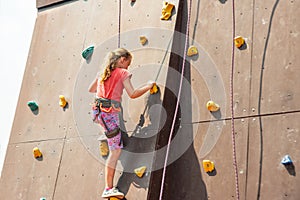 The girl on the tower of climbers conquers the peaks in an extreme park photo