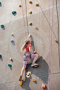 The girl on the tower of climbers conquers the peaks in an extreme park photo