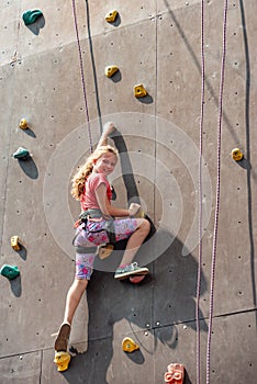 The girl on the tower of climbers conquers the peaks in an extreme park photo