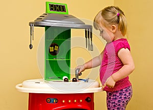 Girl and toy kitchen