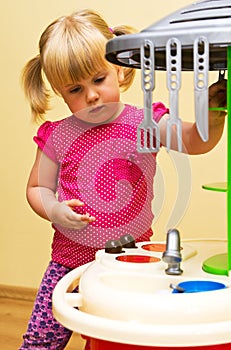 Girl and toy kitchen