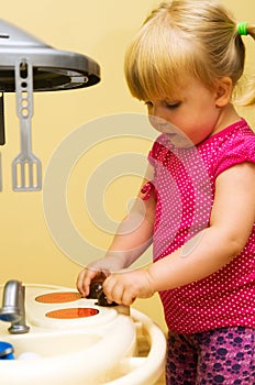 Girl and toy kitchen