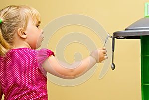 Girl and toy kitchen