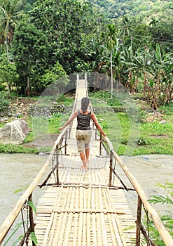Girl on traditional bridge over river photo